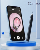Smartphone with 20x macro camera feature displaying a close-up of a ring, next to a black pen on a blue platform.